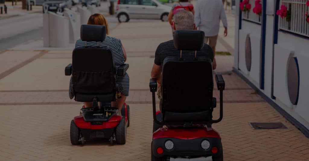 Two People In Mobility Scooters — Mobility Shop In Tweed Heads, NSW