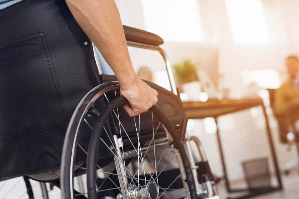 Man Sitting In A Wheelchair — Mobility Shop In Tweed Heads, NSW