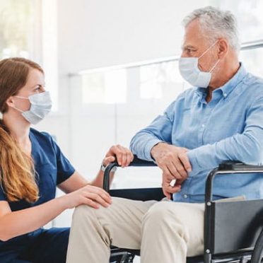 Young Nurse Taking Care Of Elderly Patient — Mobility Shop In Biggera Waters, NSW